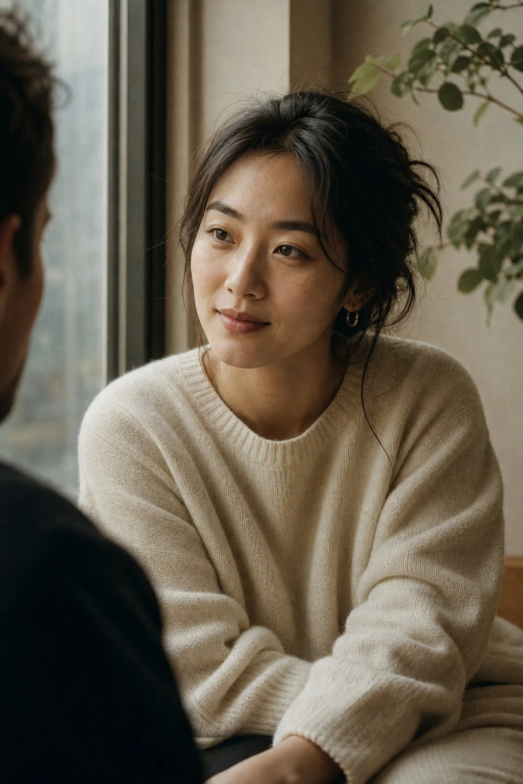 Two friends in sincere conversation at a sunlit cafe